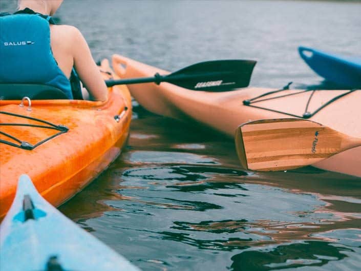 Lake kayaking in orange kayaks