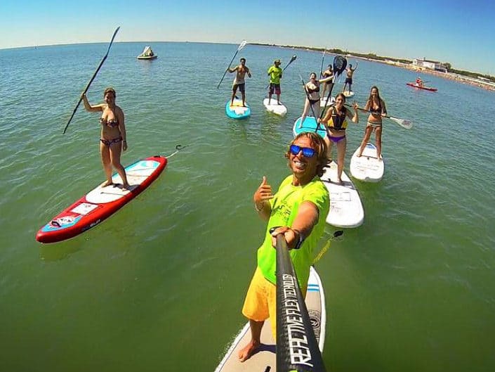 Group of young people paddle boarding 