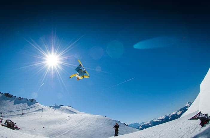 Snowboarder mid air jump - take students on a school ski trip