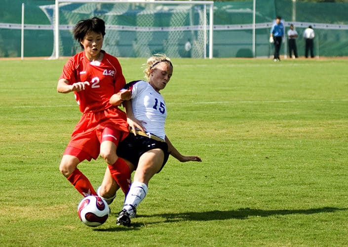 women playing football