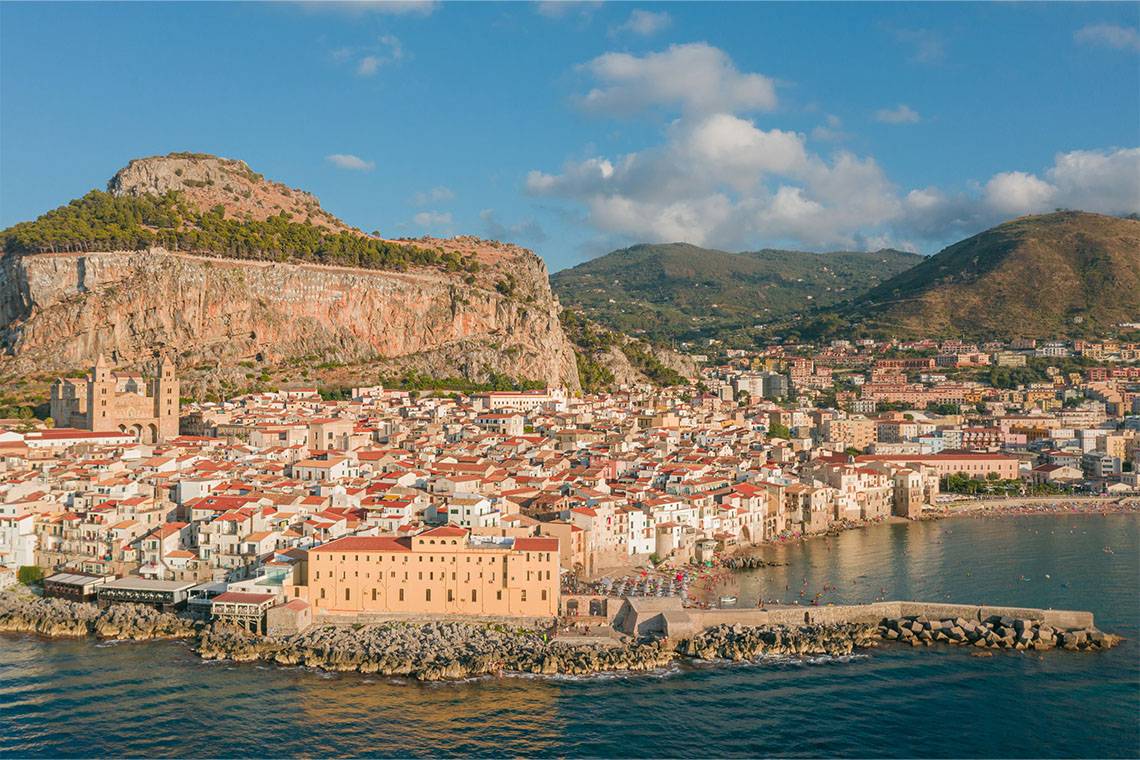 Taormina, a picturesque hilltop town on the eastern coast of Sicily, Italy, renowned for its stunning views of Mount Etna.